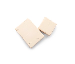 Photo of blocks of compressed yeast on white background, top view