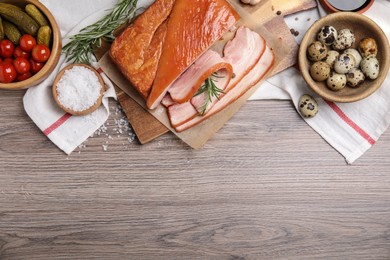 Photo of Flat lay composition with delicious smoked bacon on wooden table, space for text