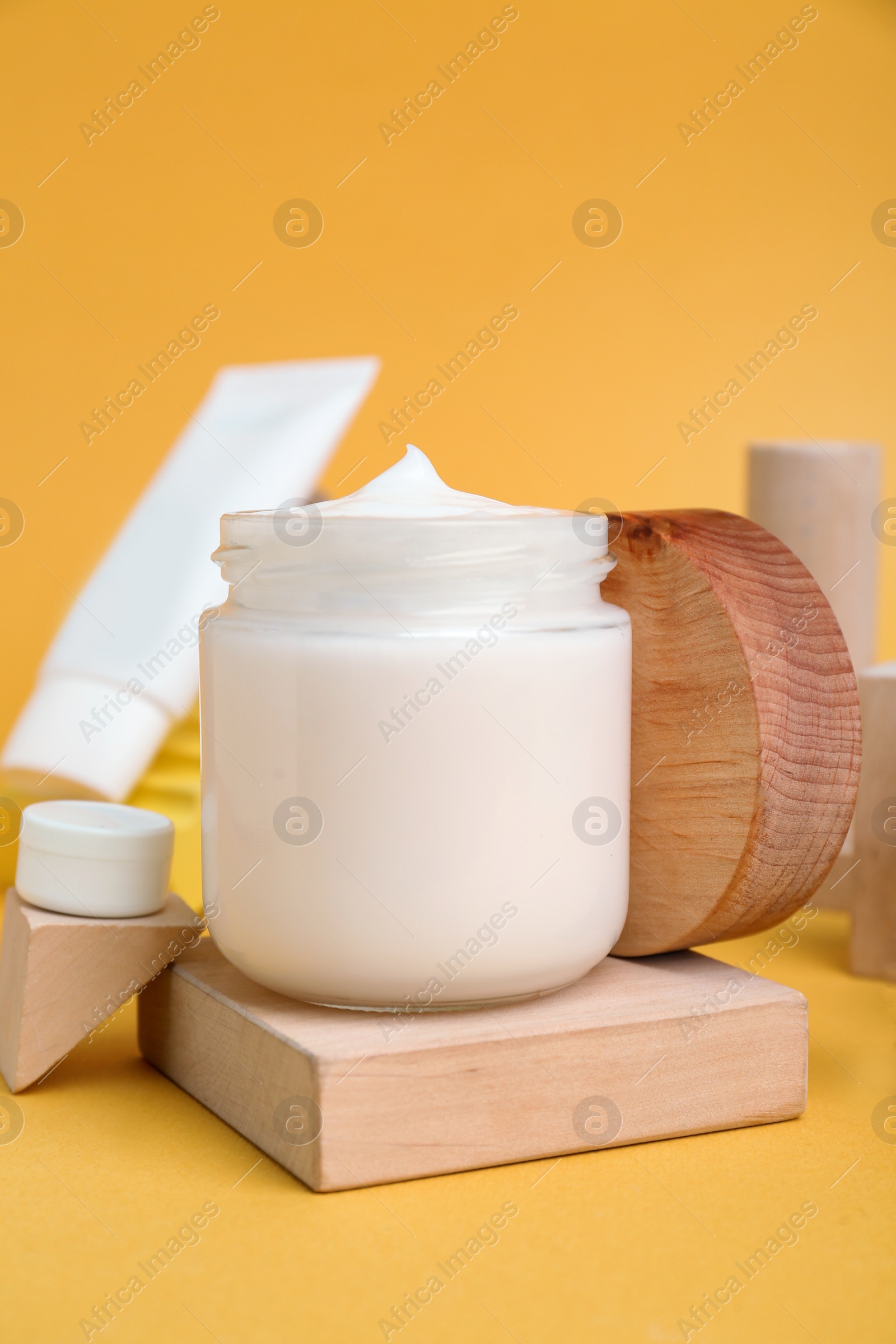 Photo of Composition with different cosmetic products on orange background