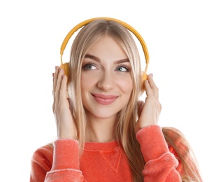 Beautiful young woman listening to music with headphones on white background