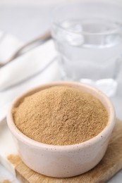 Photo of Dietary fiber. Psyllium husk powder in bowl on table