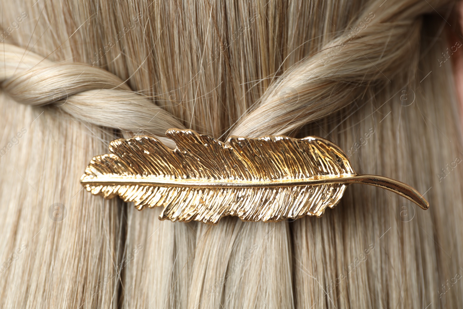 Photo of Woman with beautiful gold hair clip, closeup