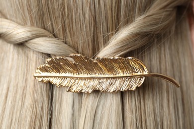 Photo of Woman with beautiful gold hair clip, closeup