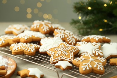 Tasty Christmas cookies with icing on table, closeup