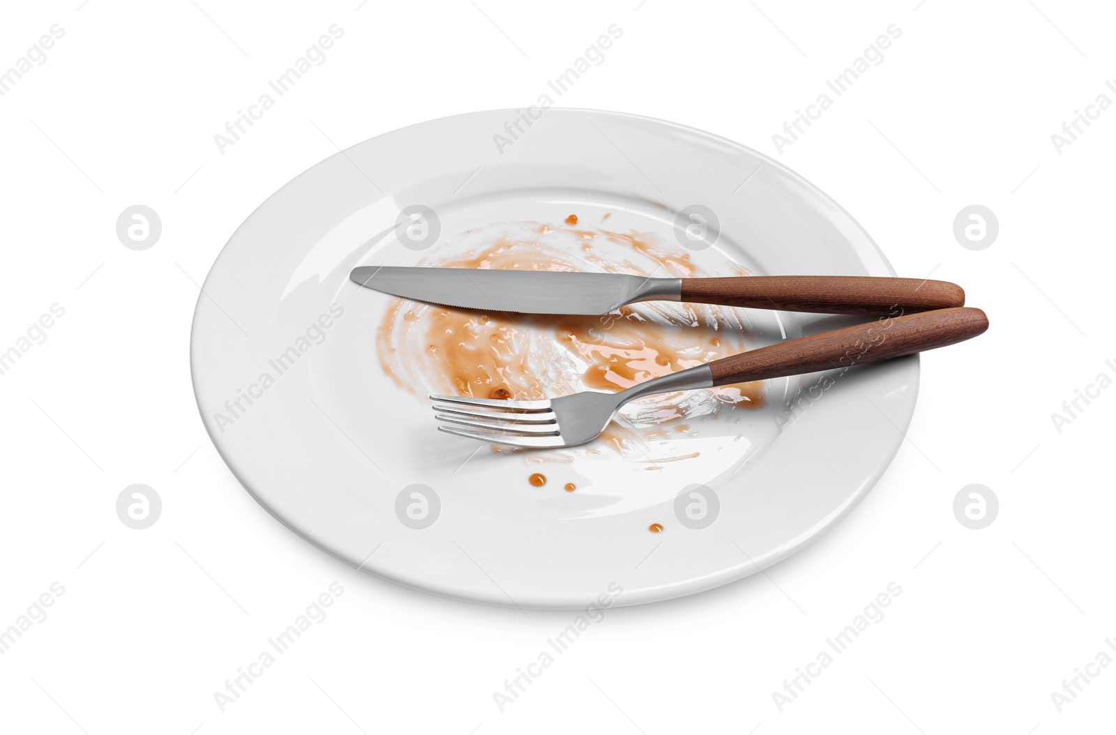 Photo of Dirty plate and cutlery on white background