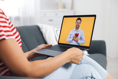 Image of Long distance love. Woman having video chat with her boyfriend via laptop at home, closeup