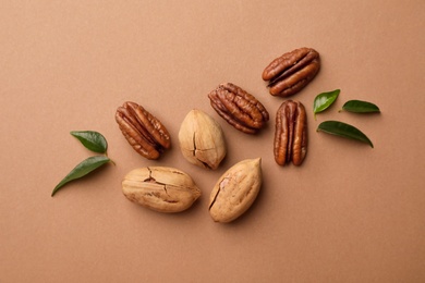 Photo of Flat lay composition with pecan nuts on color background