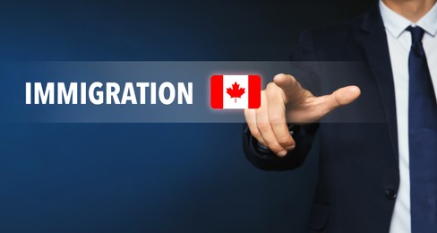Image of Immigration. Businessman touching digital screen with word and flag of Canada on dark blue background, closeup