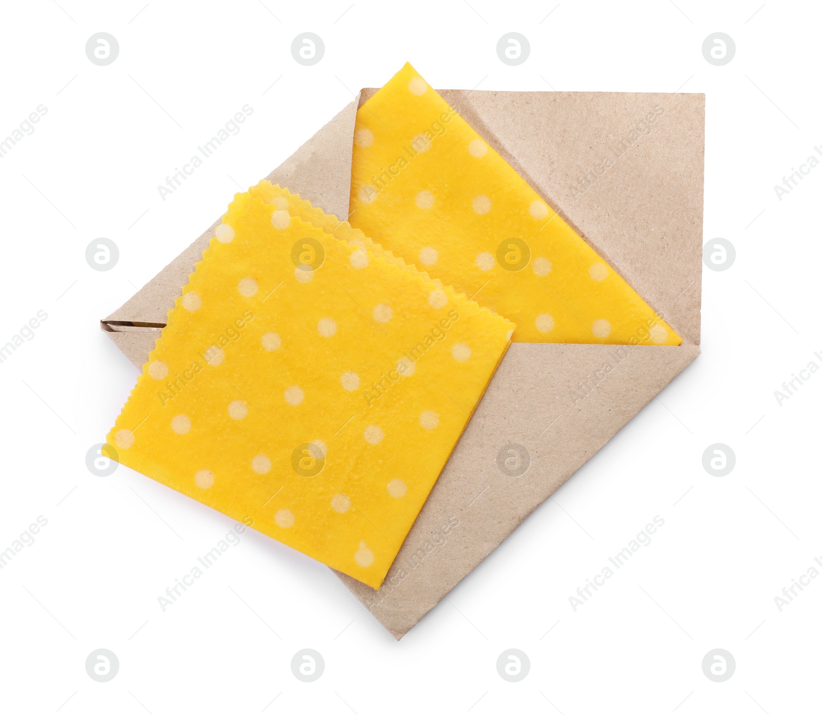 Photo of Yellow reusable beeswax food wraps on white background, top view