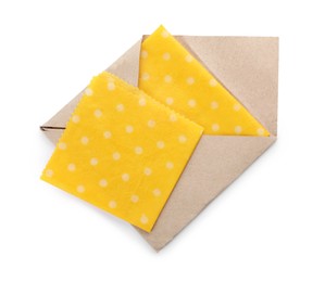 Photo of Yellow reusable beeswax food wraps on white background, top view