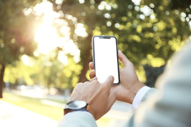 Man using modern mobile phone in park, closeup