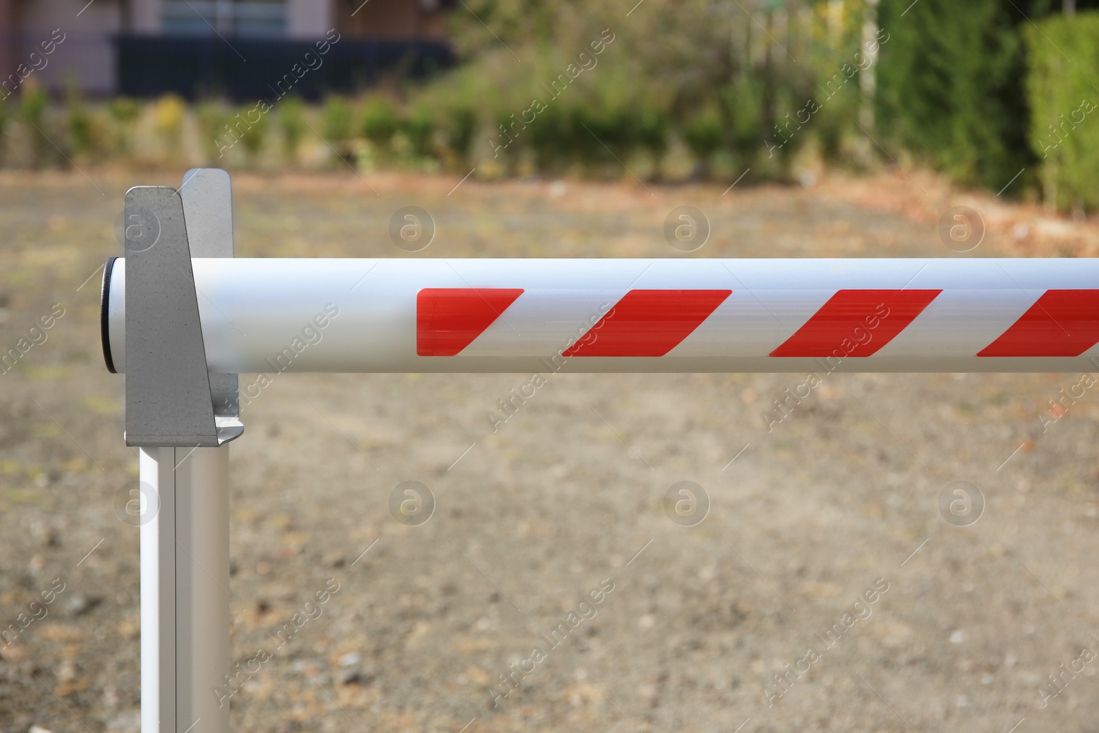 Photo of Closed automatic boom barrier on sunny day outdoors, closeup