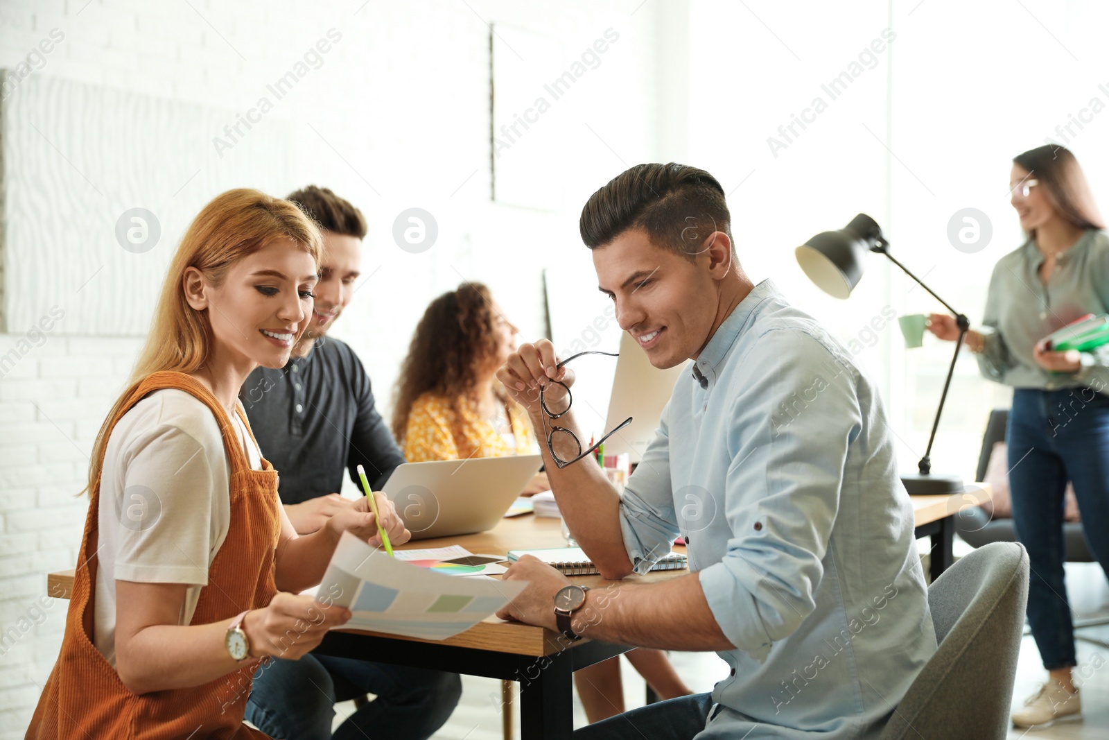 Photo of Team of professional designers working in office