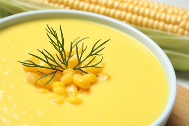 Delicious creamy corn soup on table, closeup