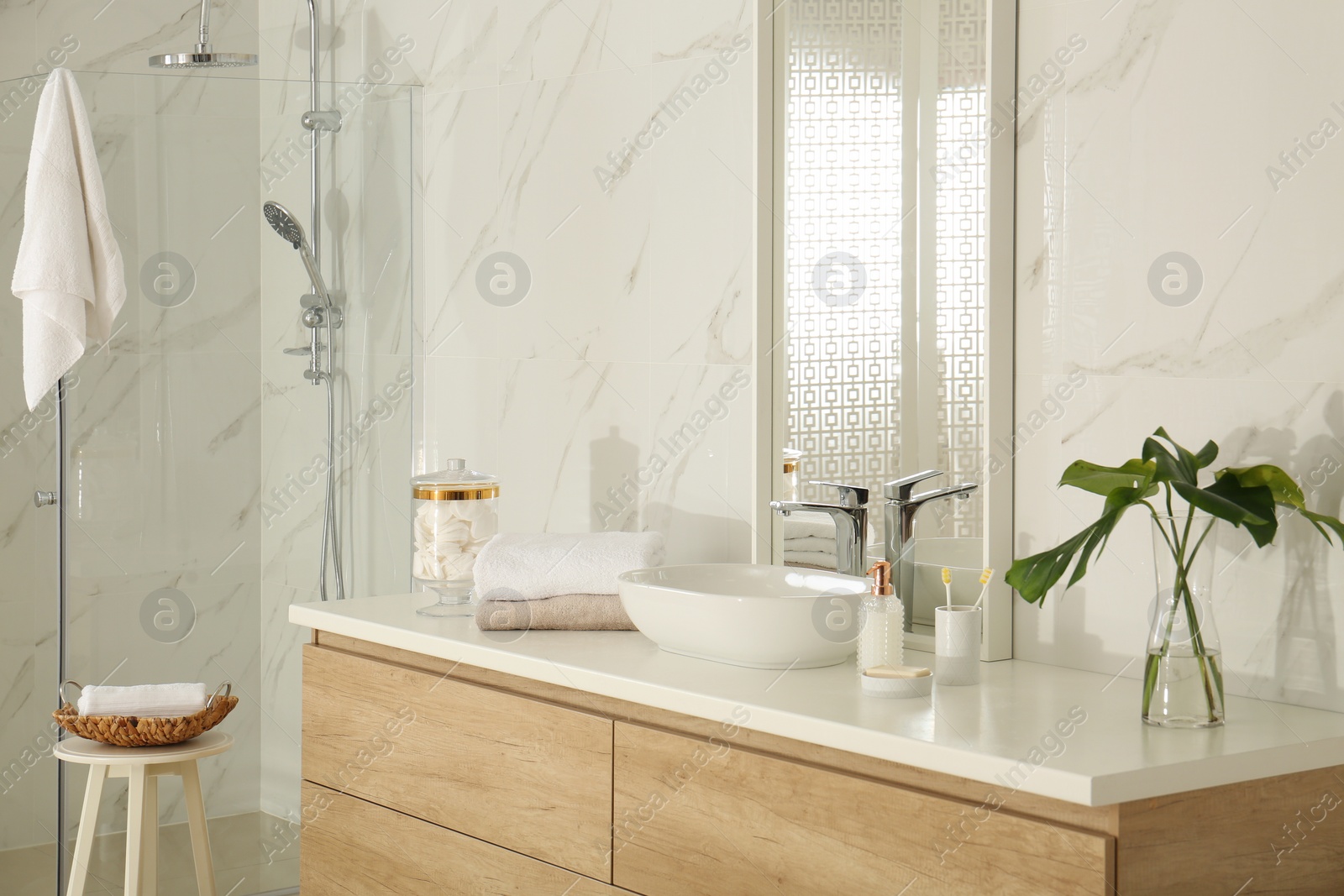 Photo of Large mirror and vessel sink in stylish bathroom