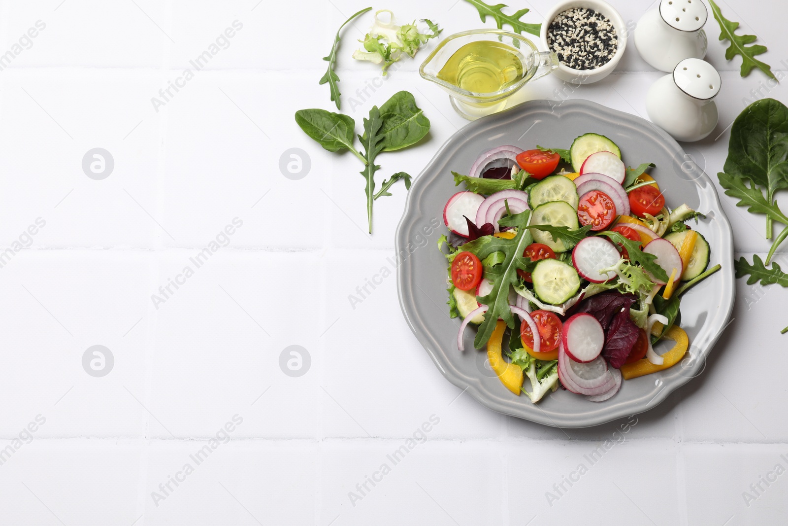 Photo of Balanced diet and vegetarian foods. Plate with different delicious products on white tiled table, flat lay