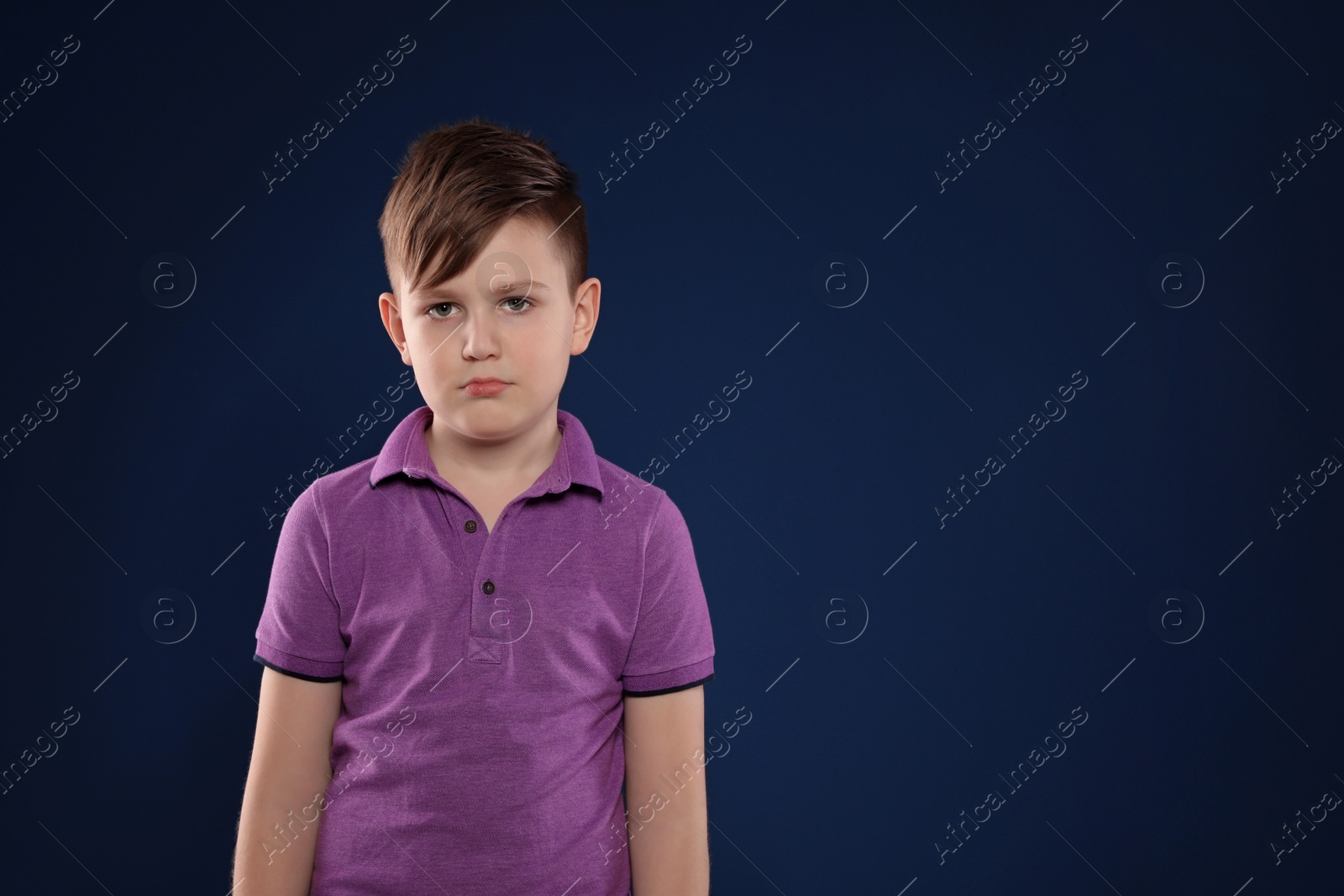 Photo of Portrait of emotional boy on color background. Space for text