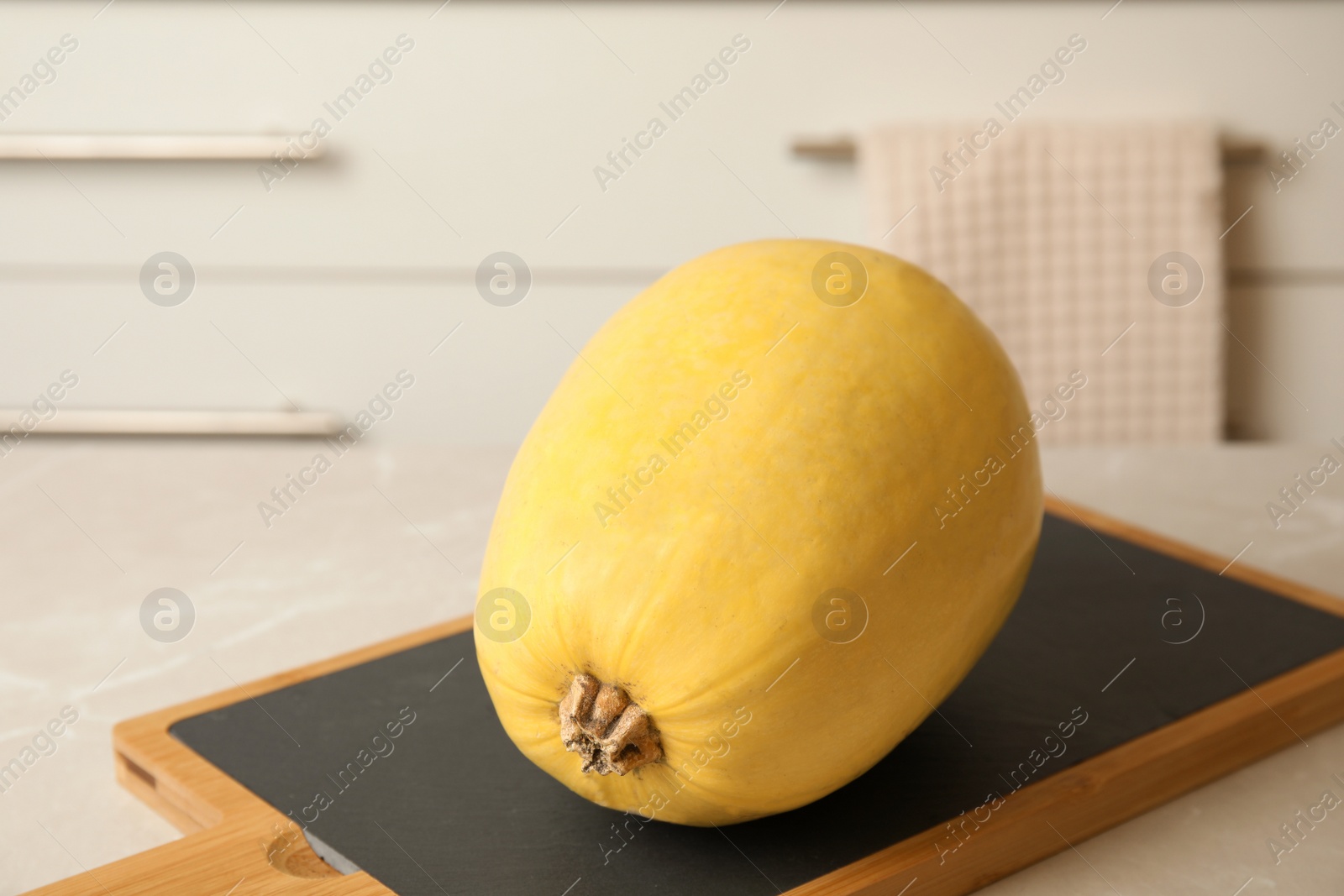 Photo of Whole ripe spaghetti squash on table indoors