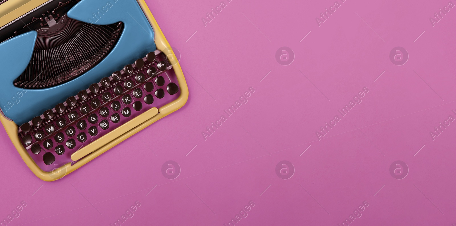 Image of Copywriter. Vintage typewriter on pink background, top view. Banner design with space for text