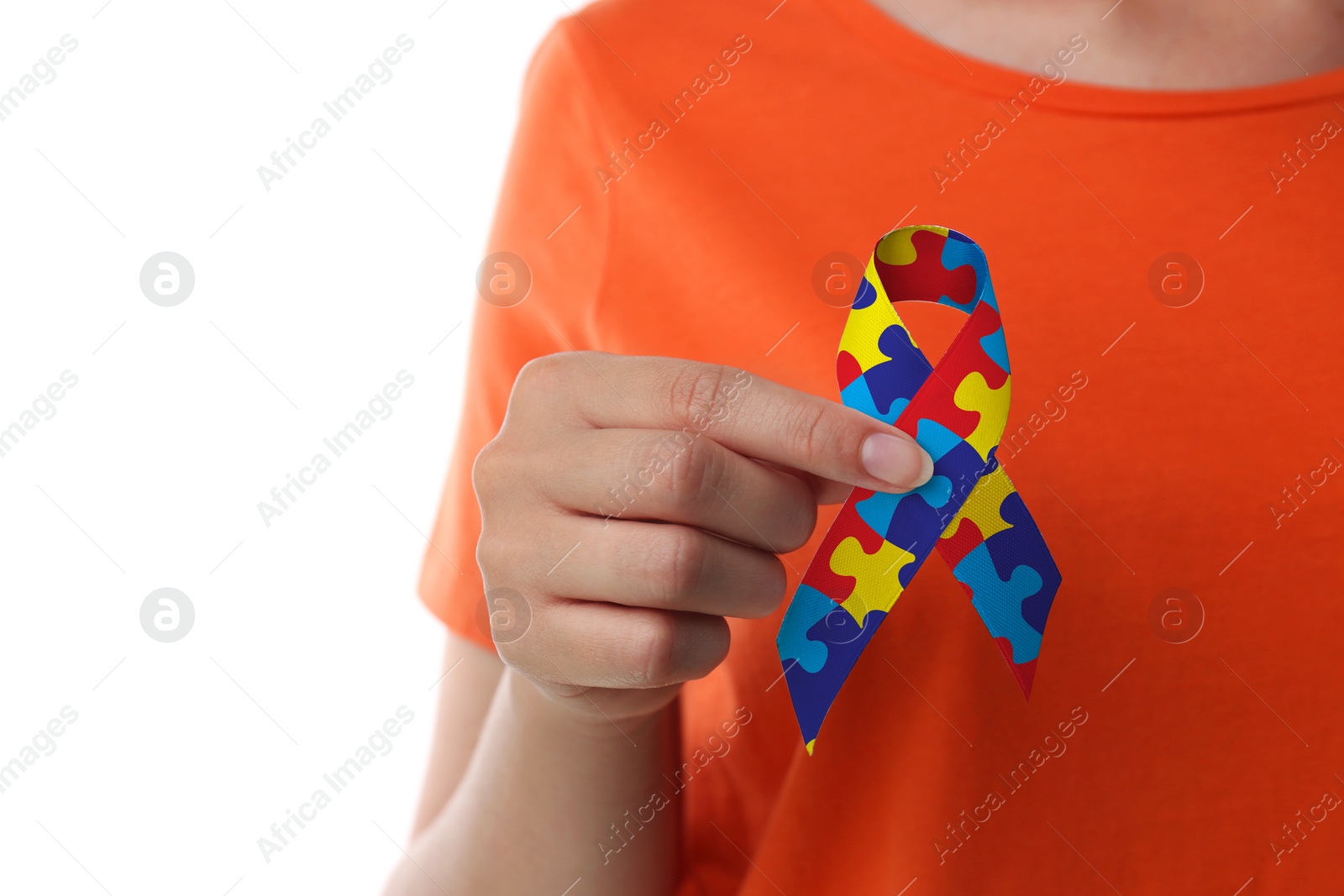 Image of World Autism Awareness Day. Woman with colorful puzzle ribbon on white background, closeup