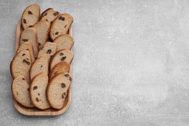 Photo of Sweet hard chuck crackers with raisins on light grey table, top view. Space for text