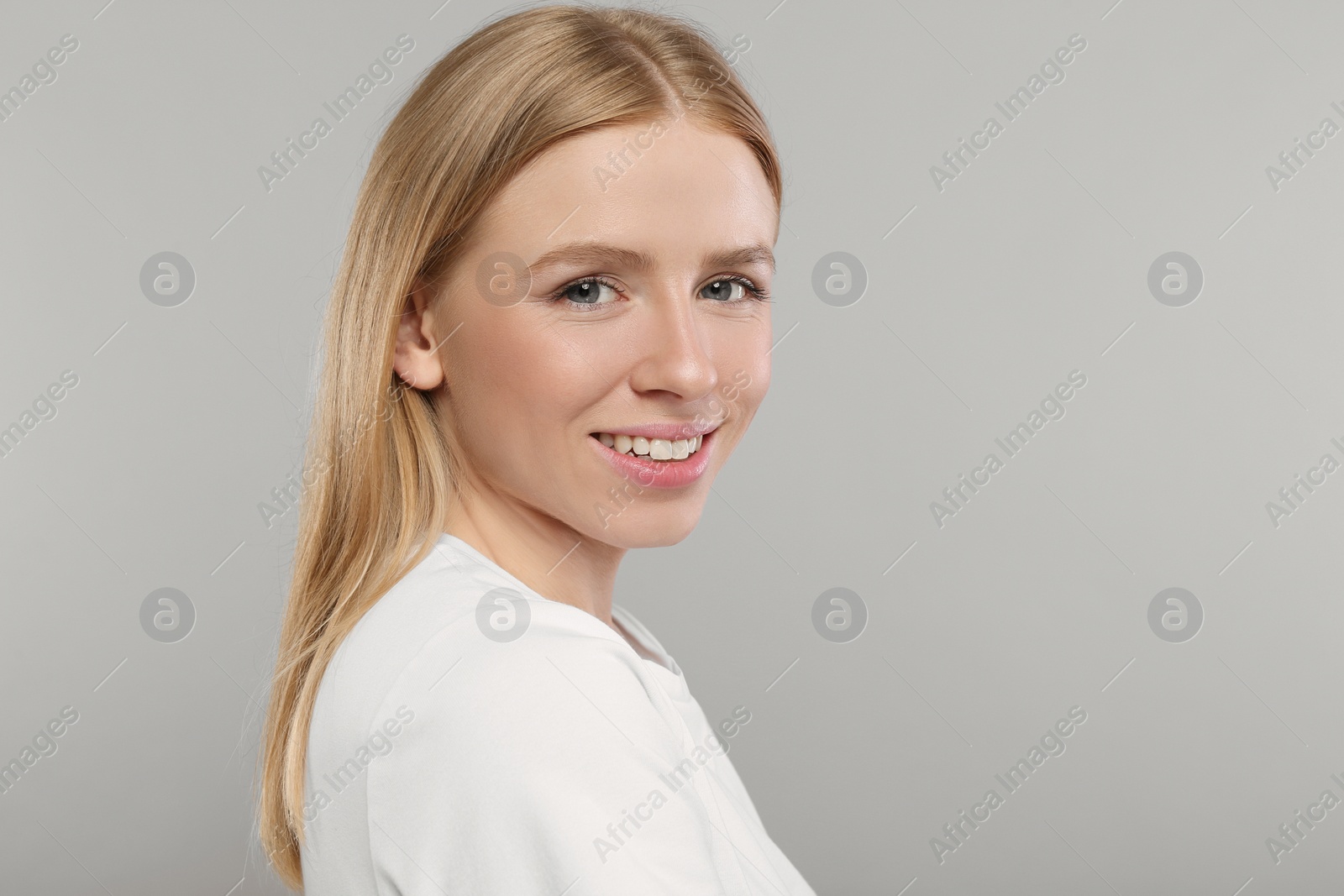 Photo of Portrait of beautiful young woman on grey background. Space for text