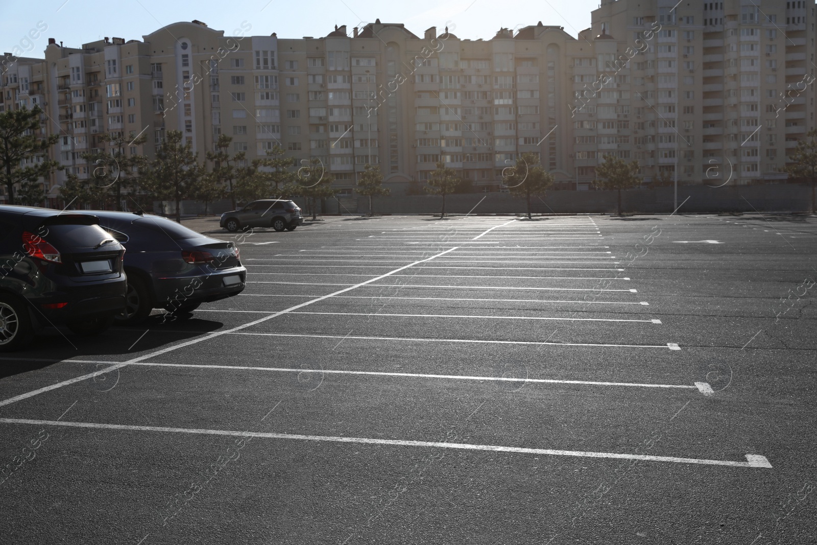 Photo of Car parking lot with white marking outdoors