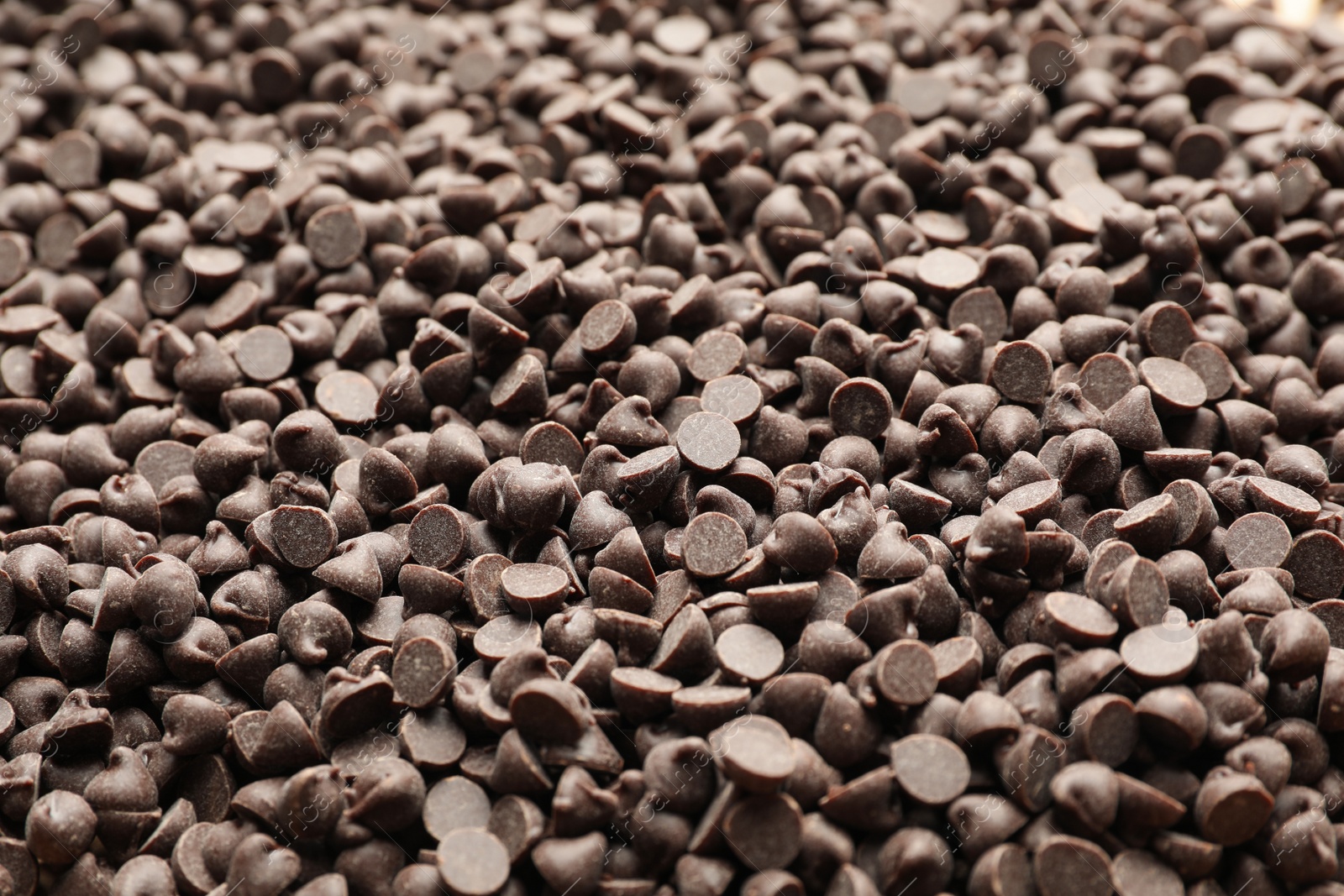 Photo of Delicious chocolate chips as background, closeup view