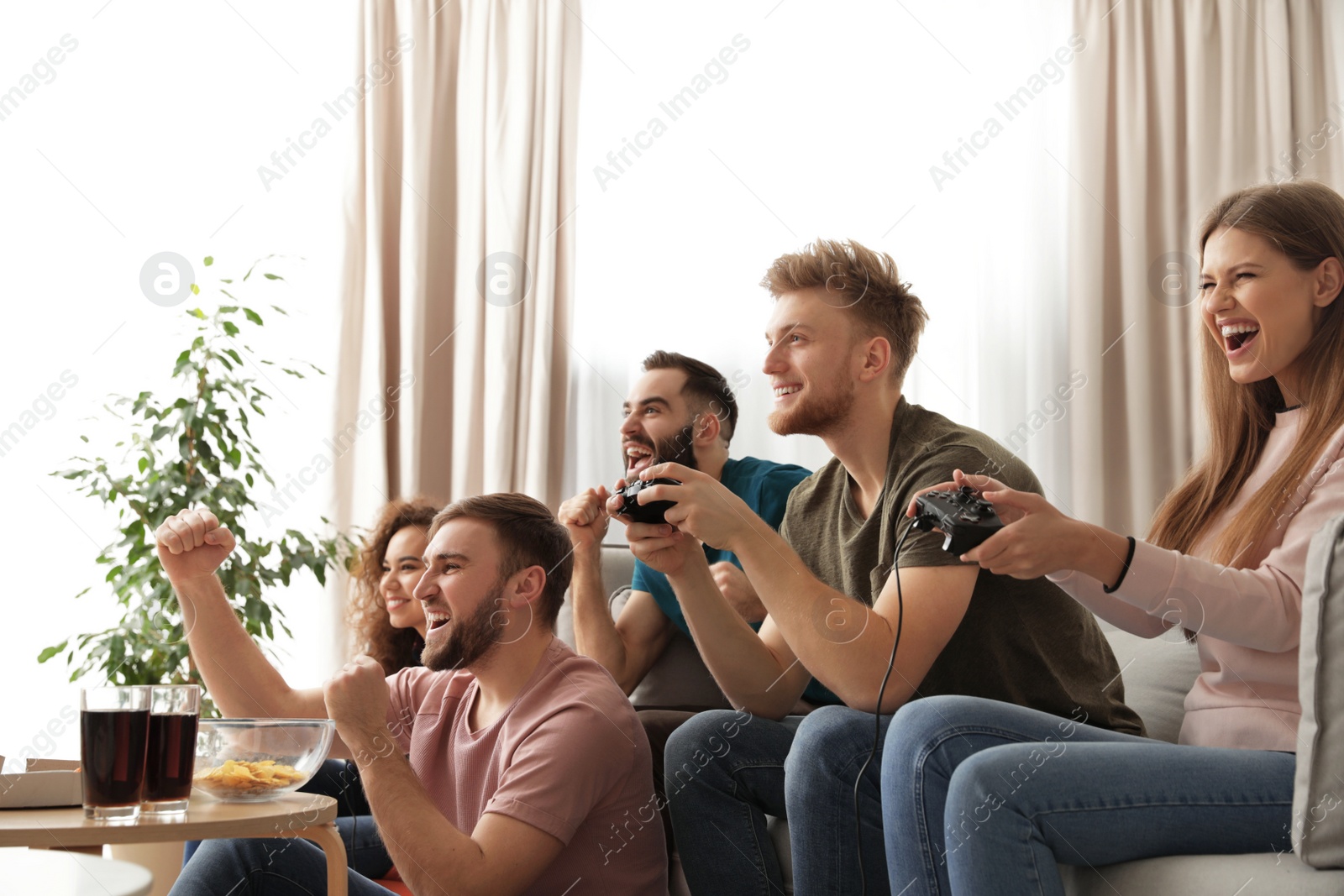 Photo of Emotional friends playing video games at home