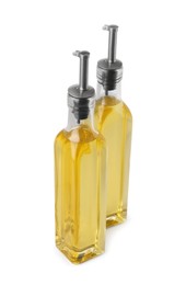 Glass bottles of cooking oil on white background