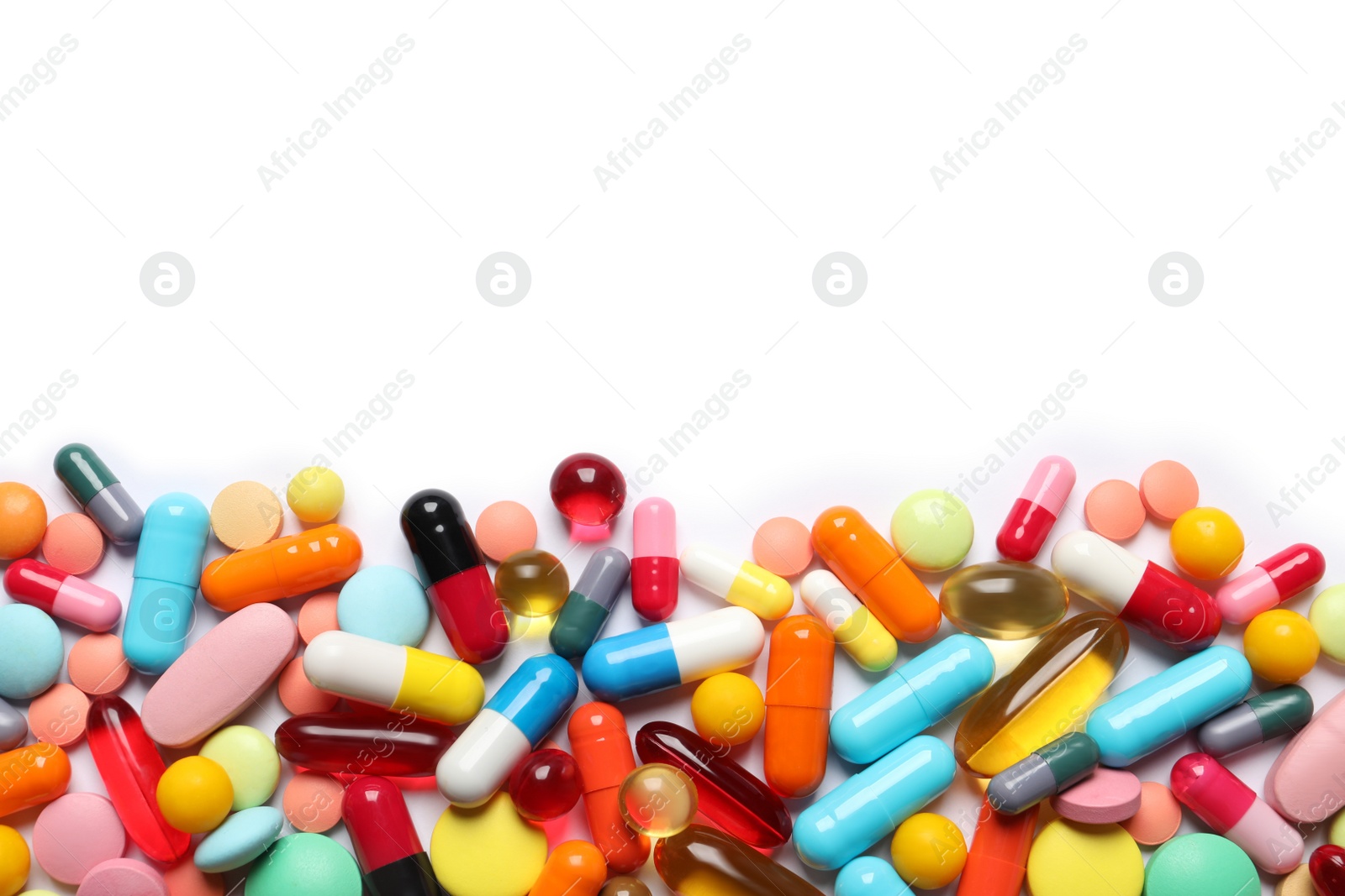 Photo of Lots of different colorful pills isolated on white, top view