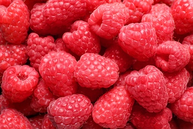 Photo of Fresh sweet ripe raspberries as background, closeup