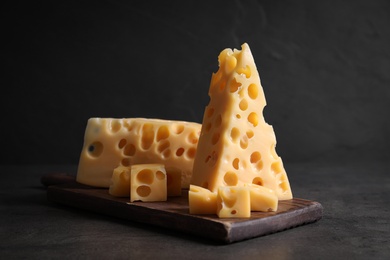 Photo of Tasty fresh cheese on dark grey table