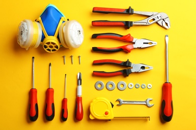 Photo of Flat lay composition with construction tools on color background