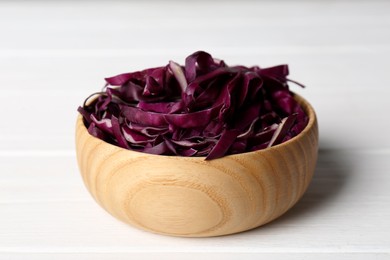 Photo of Fresh chopped red cabbage in wooden bowl on white table