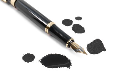 Photo of Stylish black fountain pen and blots of ink isolated on white