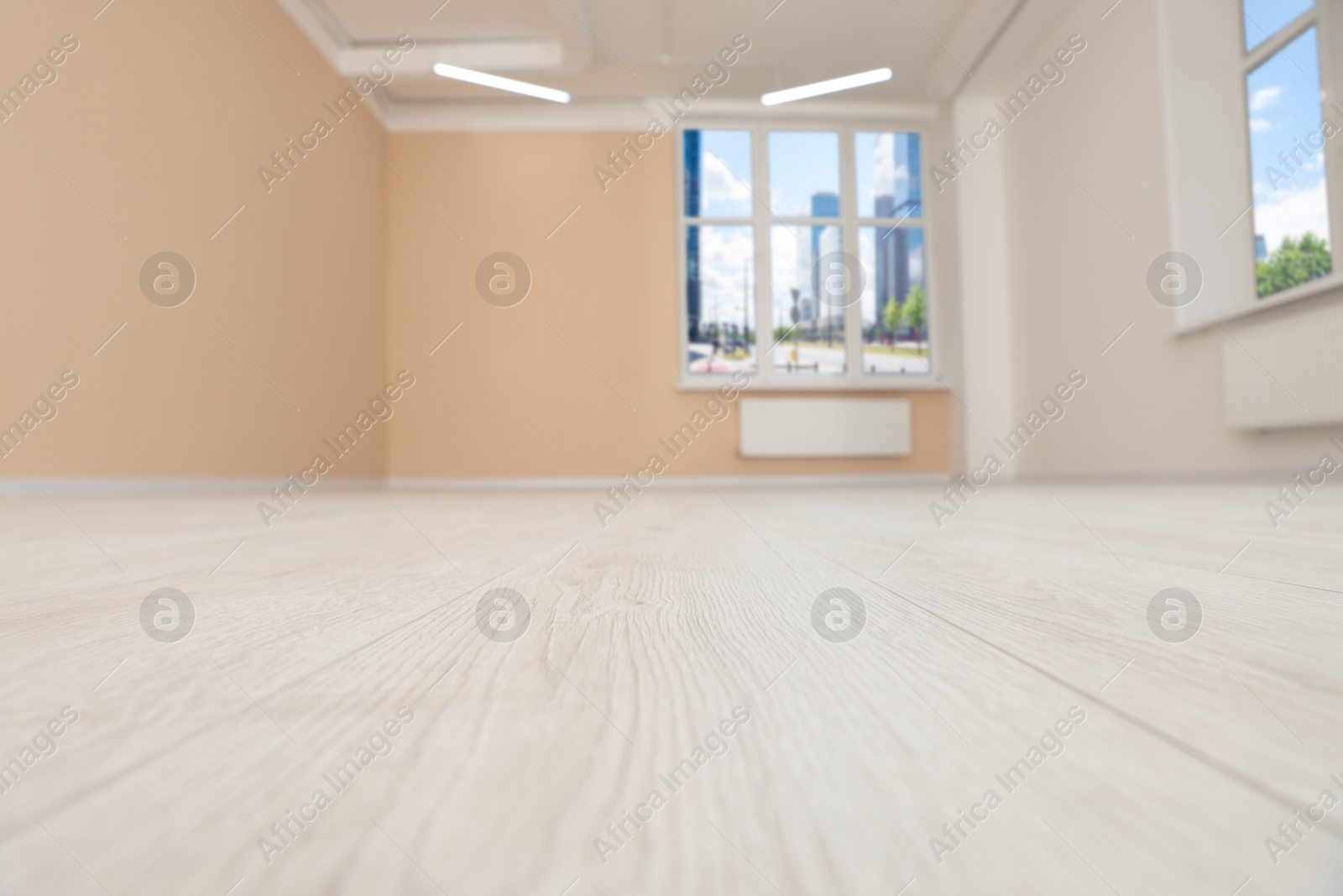 Photo of New empty office room with clean windows and beige walls