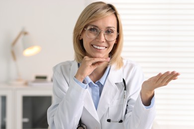 Portrait of smiling doctor on blurred background