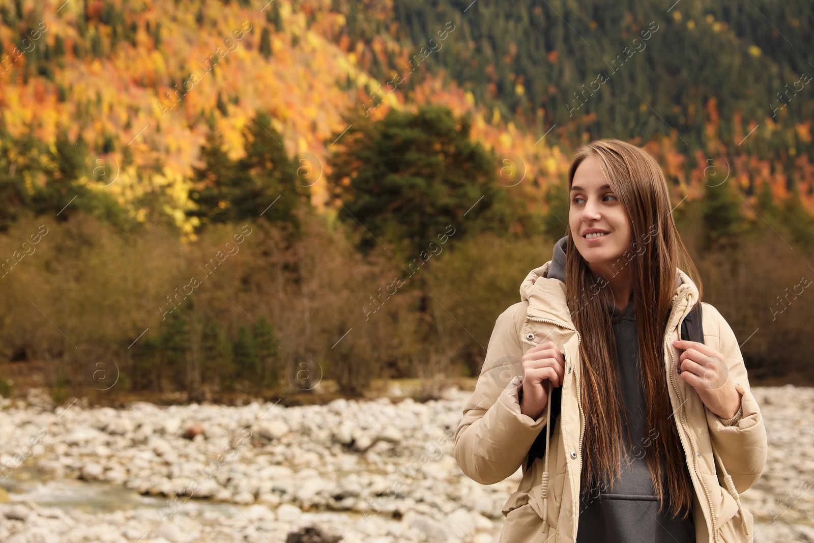 Photo of Happy woman with backpack in beautiful mountains. Space for text