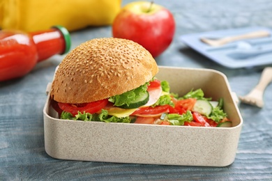 Photo of Lunch box with appetizing food on wooden table