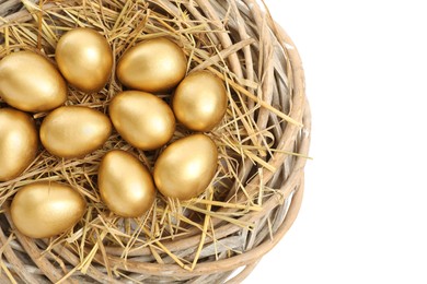 Shiny golden eggs in nest on white background, top view
