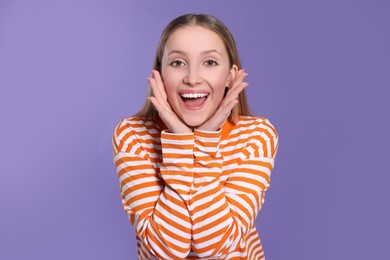 Photo of Portrait of beautiful teenage girl on purple background