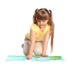 Photo of Portrait of cute little girl reading book on white background