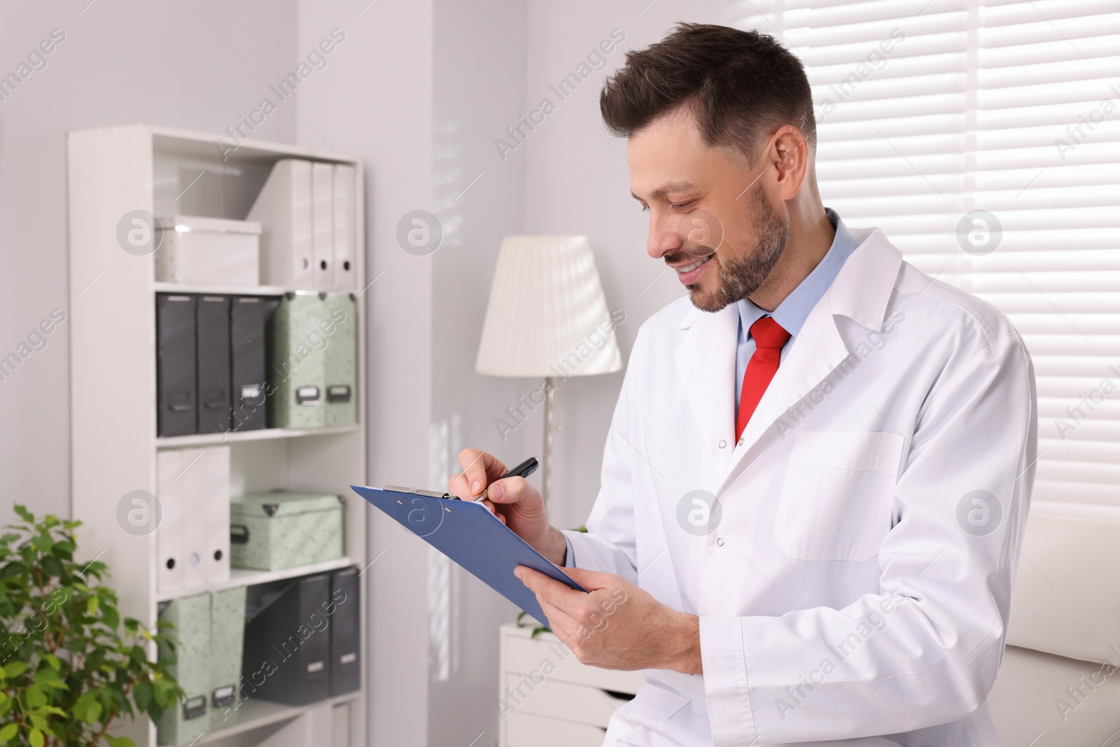 Photo of Doctor with clipboard in clinic. Patient consultation