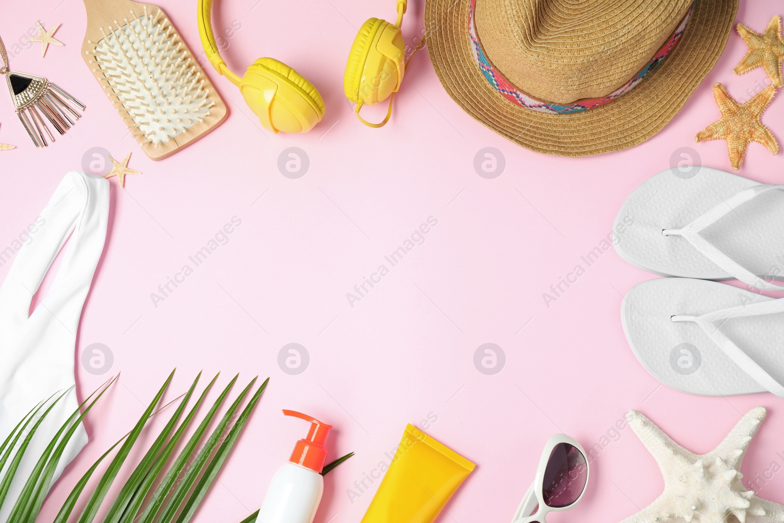 Photo of Flat lay composition with beach accessories on pink background, space for text