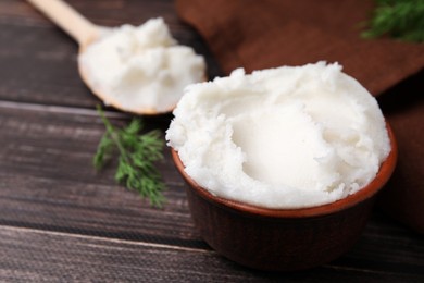 Photo of Delicious pork lard in bowl on wooden table, closeup. Space for text