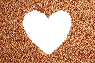 Photo of Frame made of uncooked buckwheat on white background, top view