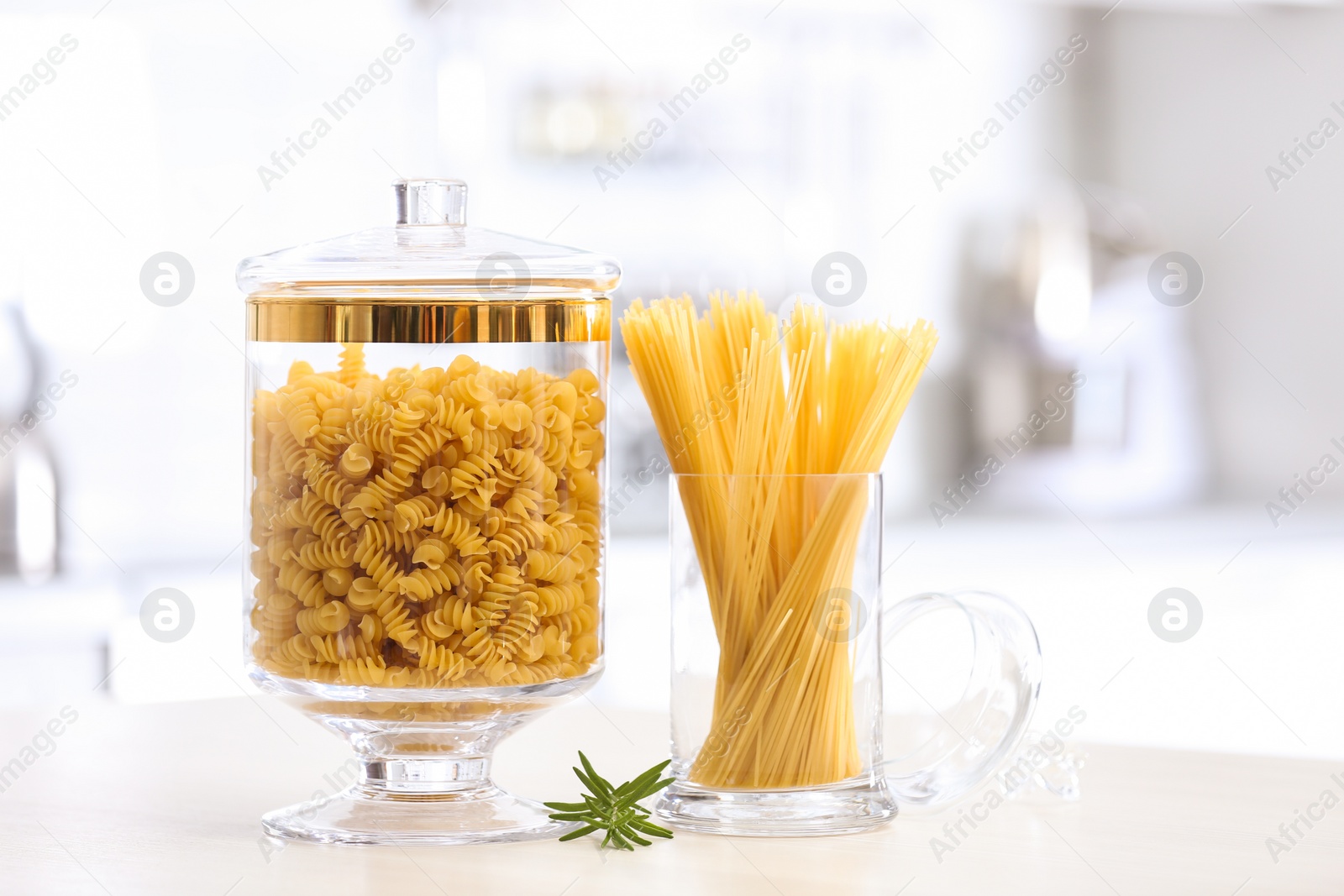 Photo of Raw pasta on wooden table in modern kitchen