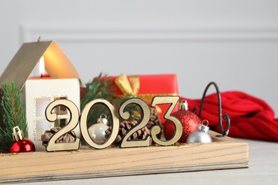 Number 2023 and festive decor on white table. Happy New Year