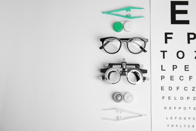 Photo of Different ophthalmologist tools on white background, flat lay